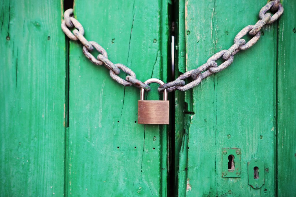 Lock and Chain on Wooden Door