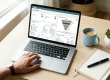 Small business owner reviewing CRM pipeline and order management dashboard on laptop